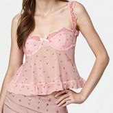 Pink lace top worn by a model on a plain background